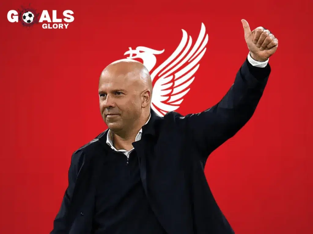 A football manager giving a thumbs-up in front of a red background featuring a stylized Liverbird emblem, symbolizing Liverpool FC. The "Goals & Glory" logo is positioned in the top left corner.
