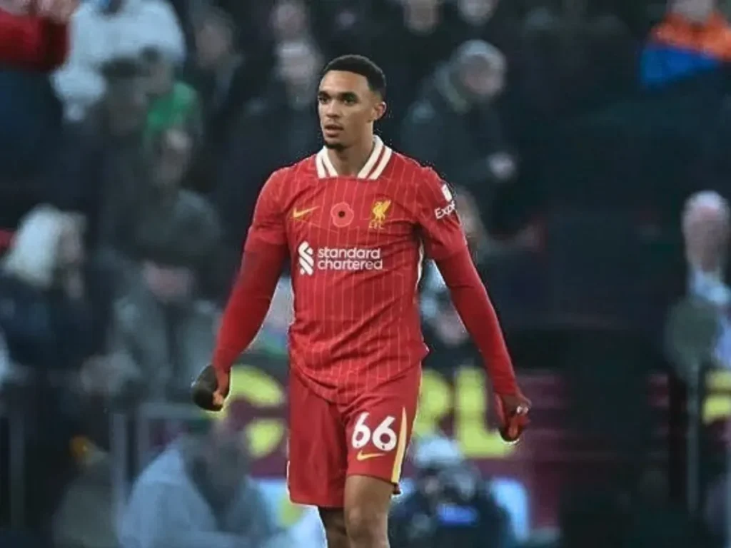 Trent Alexander-Arnold walking on the pitch in Liverpool’s red jersey during a match.
Title: Trent Alexander-Arnold in Action for Liverpool
