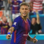 Neymar smiling in Barcelona jersey.