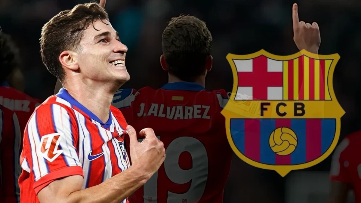 The image features Julián Álvarez in an Atlético Madrid jersey, smiling and pointing to the badge. In the background, his name and number appear on another player's jersey, alongside the FC Barcelona logo, hinting at transfer speculation.